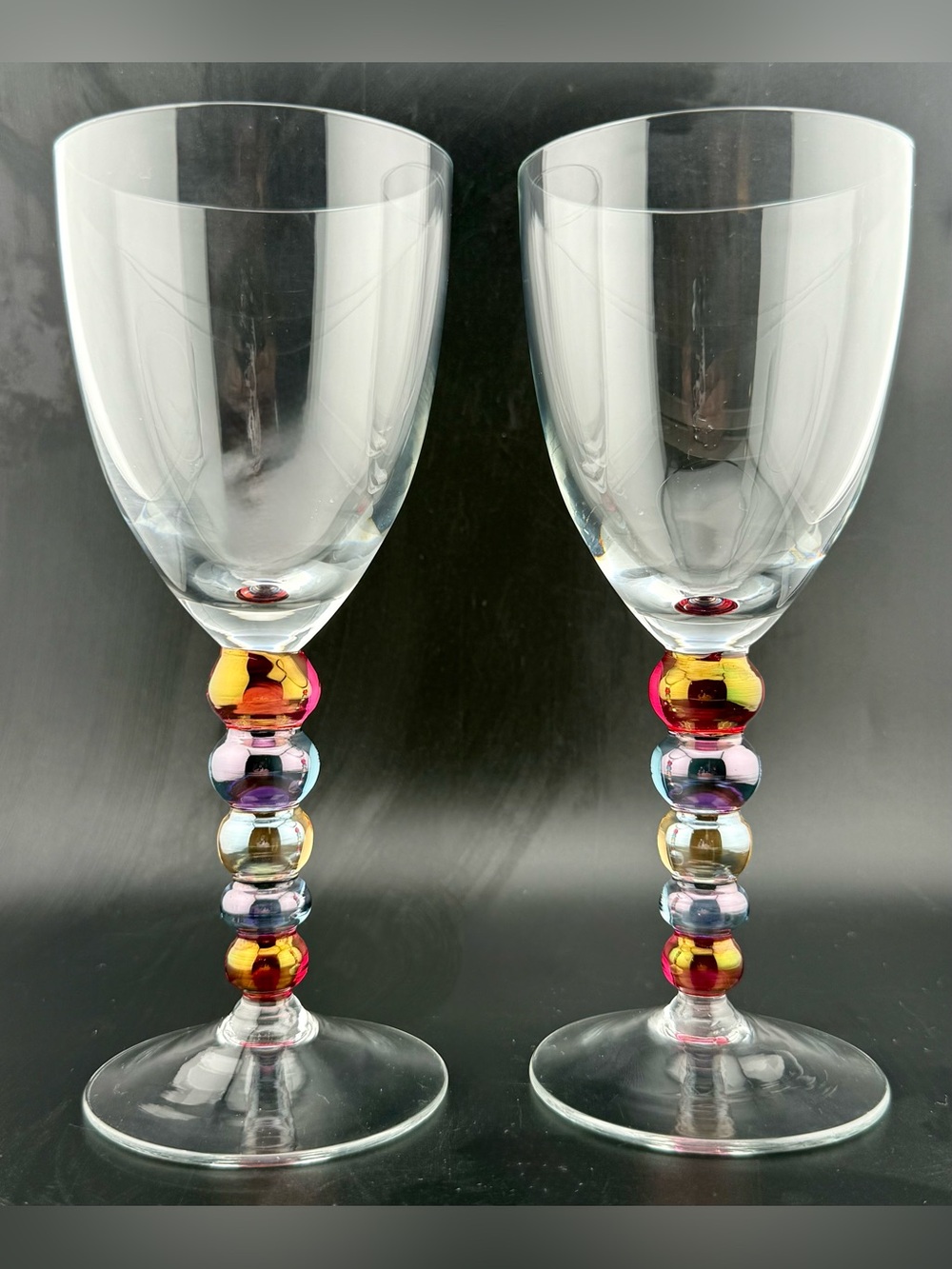 2 colored iridescent ball stem wine glasses.